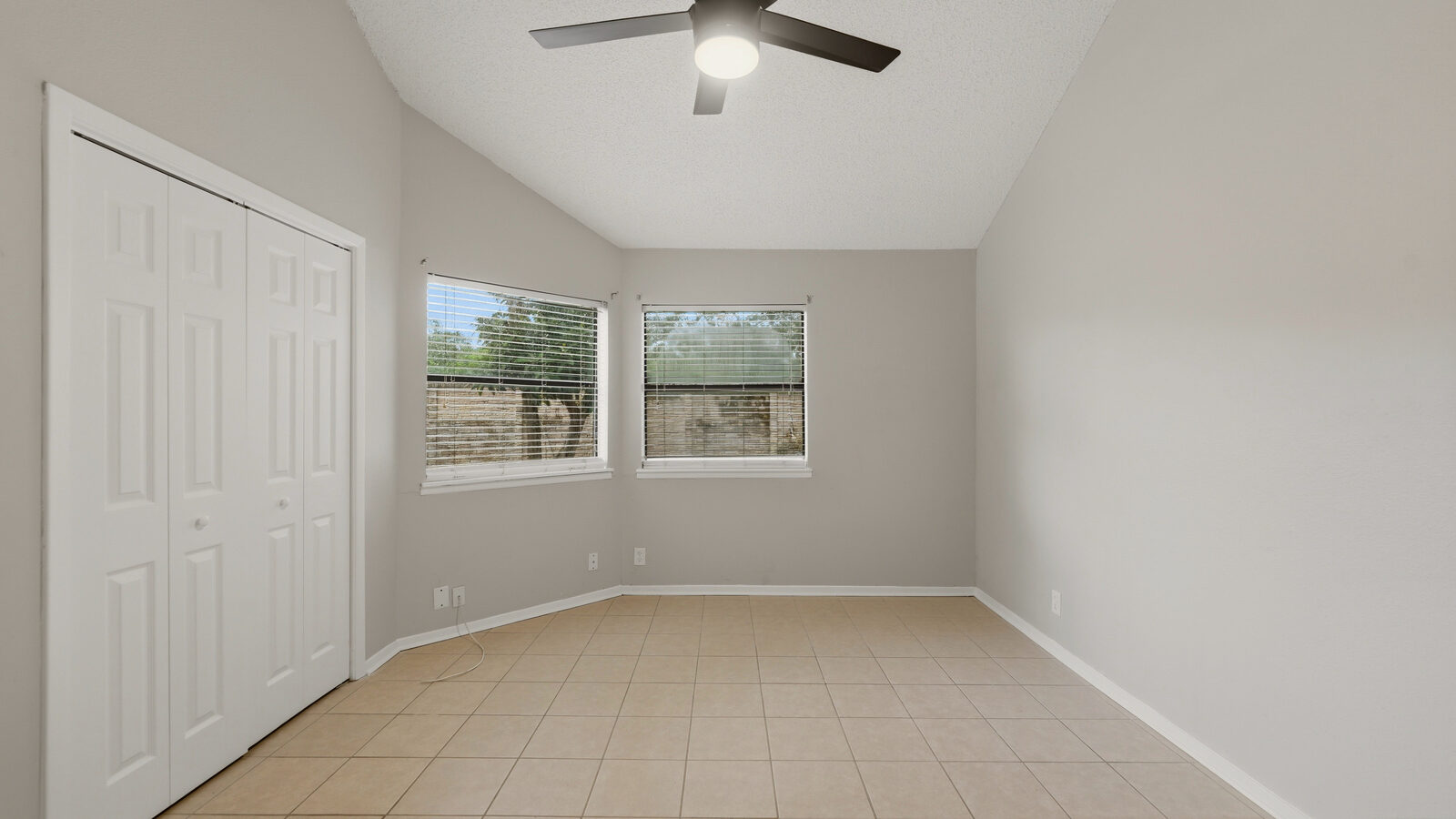 Primary bedroom with vaulted ceiling and window seating nook