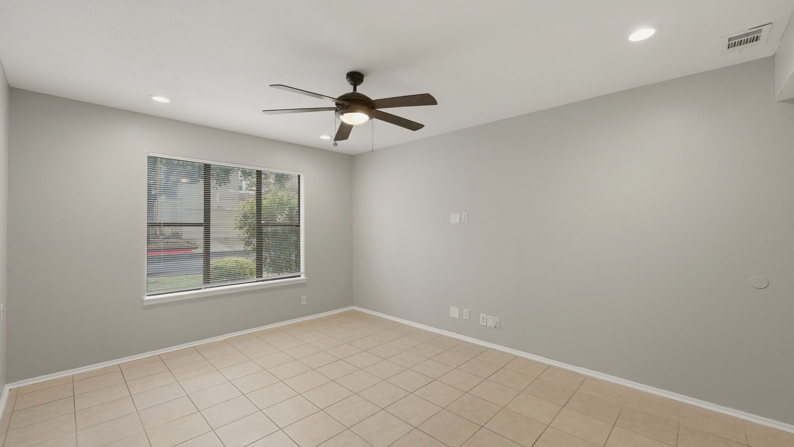 Primary bathroom with double vessel sinks and glass walk-in shower, straight-on view