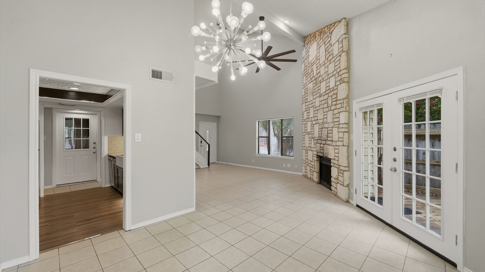 Kitchen with farmhouse sink, stone accent wall, and pass-through to the dining nook